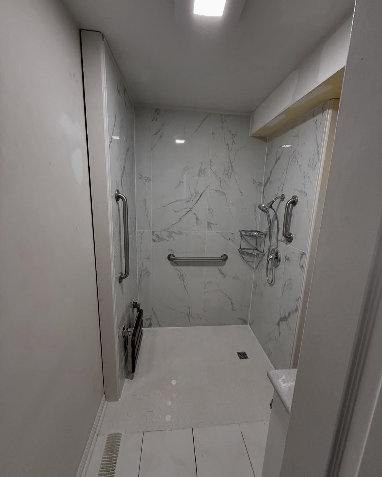 Accessible walk-in shower with grab bars