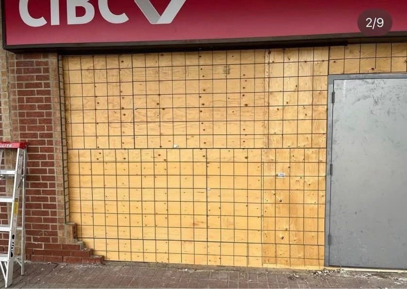 Commercial storefront renovation in progress, boarded during construction