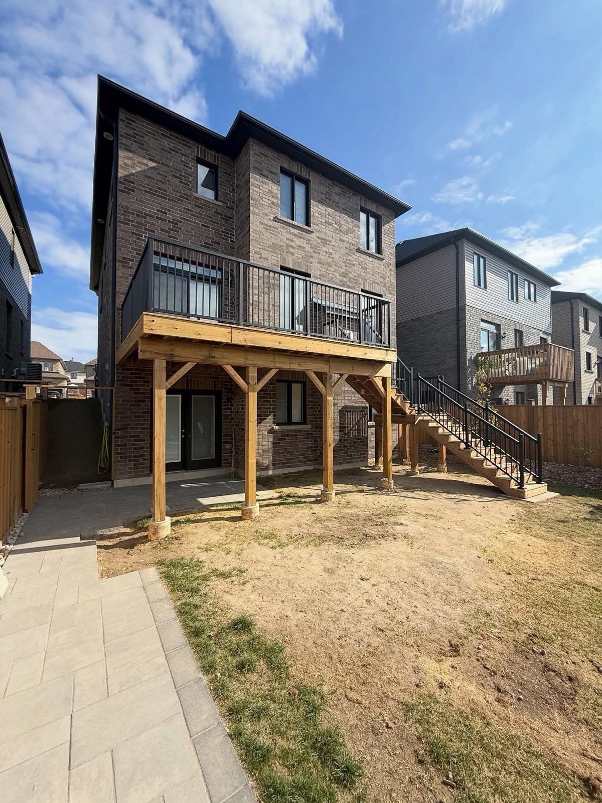 Two-storey deck with black railings, front view